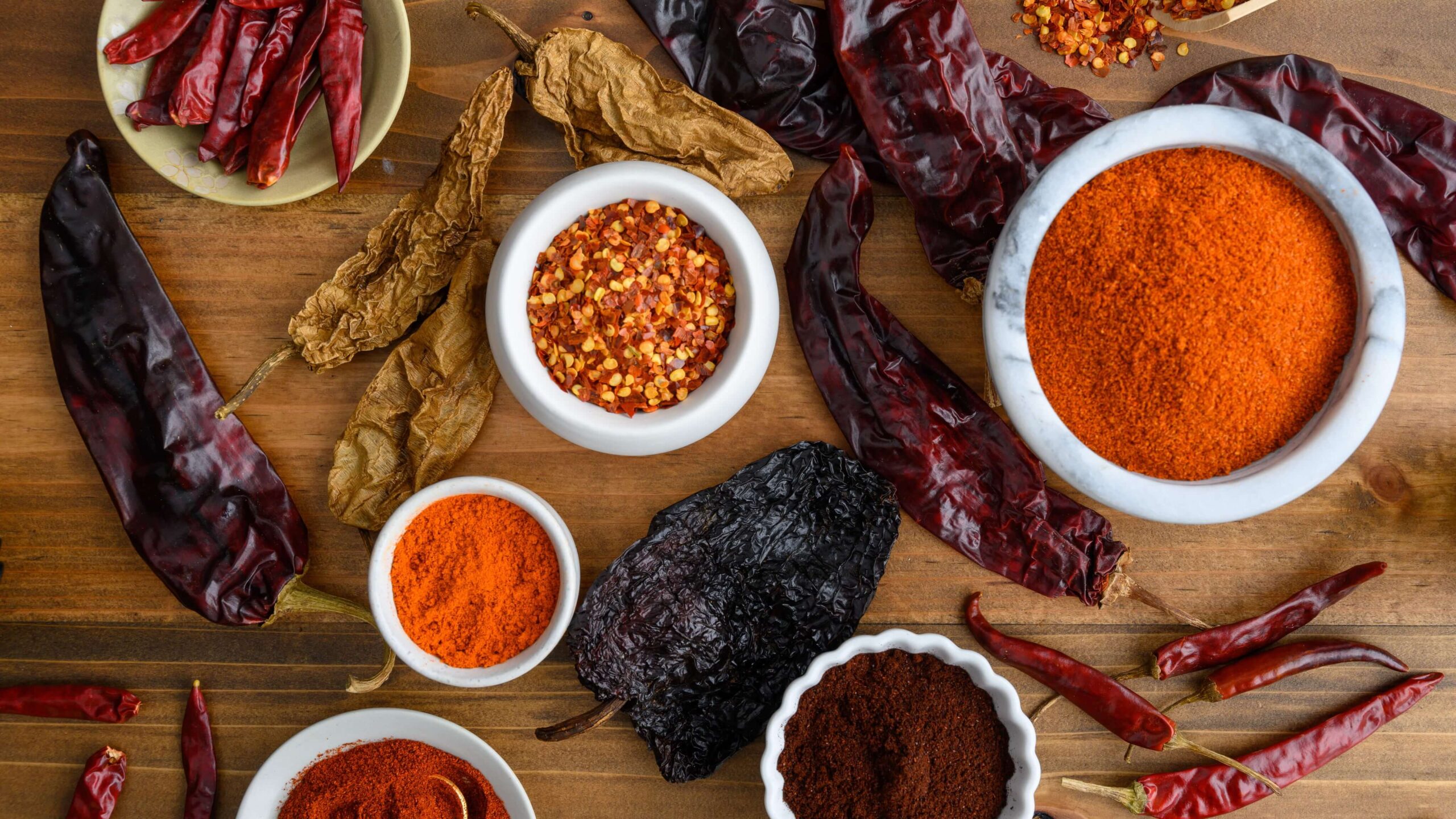 assorted chili peppers and powders