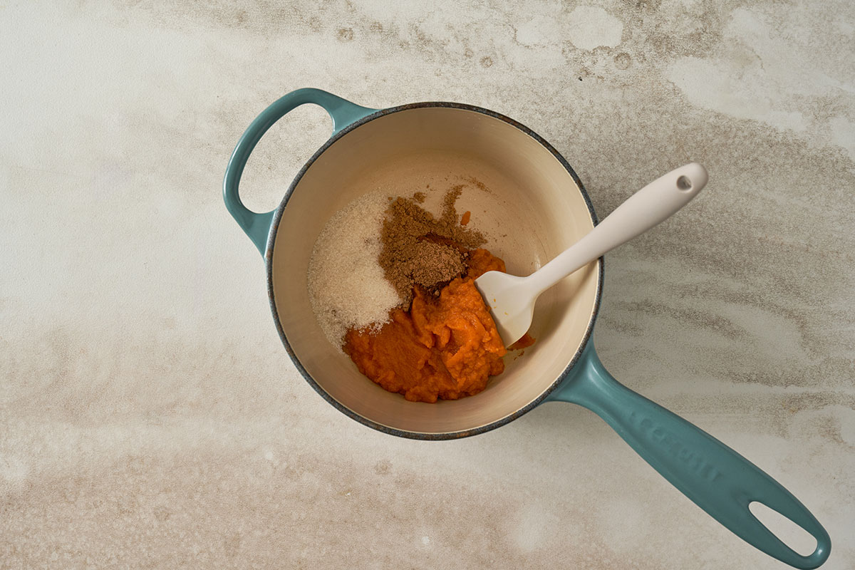 Cooking the pumpkin puree, pumpkin pie spice, and sugar to make a thick, flavorful filling for Pumpkin Sesame Balls, by Pacific Spice.