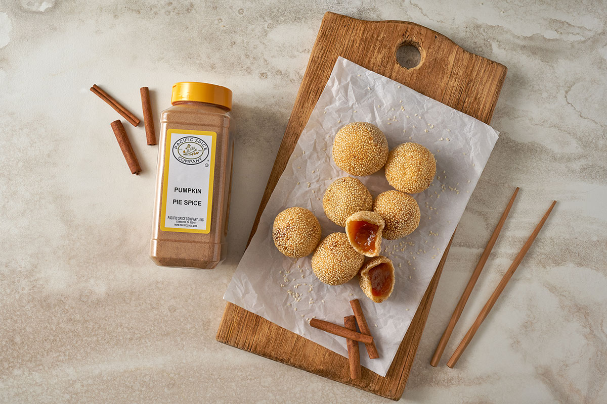 An overhead view of Pumpkin Sesame Balls, golden and crispy on the outside, arranged on a plate, featuring pumpkin pie spice by Pacific Spice.